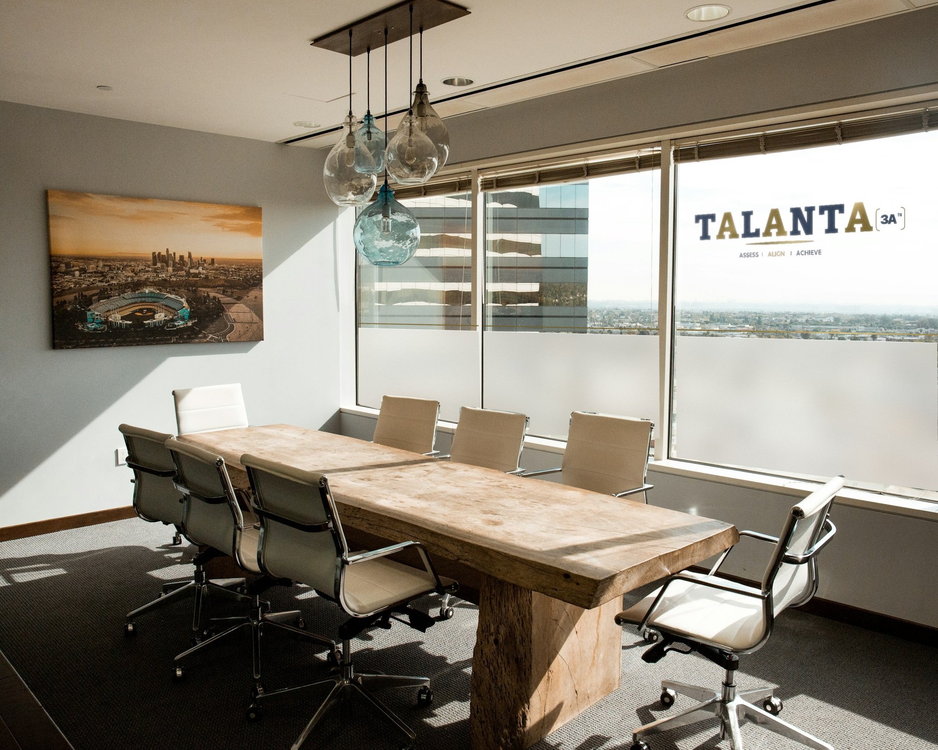 Meeting room with a city view and the TALANTA 3A logo painted on the window